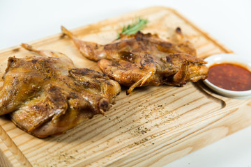 Beautiful juicy chicken grilled with sauce on a wooden Board