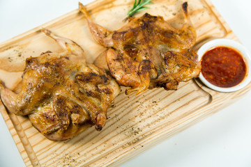 Beautiful juicy chicken grilled with sauce on a wooden Board
