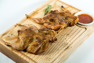 Beautiful juicy chicken grilled with sauce on a wooden Board