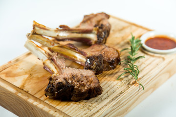 Close up view of Beautiful juicy barbecue ribs with sauce on a old wooden board