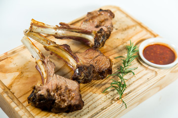 Close up view of Beautiful juicy barbecue ribs with sauce on a old wooden board