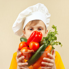 Little funny boy with the fresh vegetables