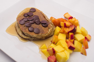 pancakes with chocolate chips and fruit salad 
