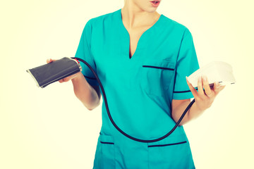 Shocked nurse or doctor with pressure gauge