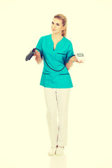 Young similing nurse or doctor with pressure gauge