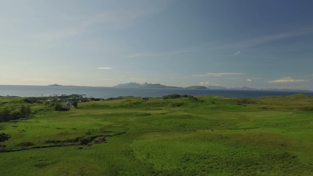 Aerial shot along the beach on the coastline during a sunset at Ardnamurchan, Scotland
