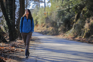 Happy young woman on road trip.