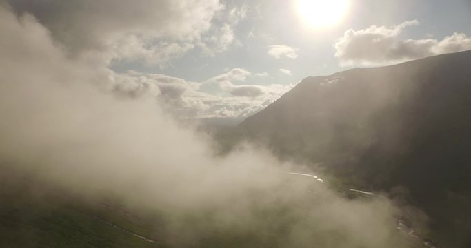 Stunning aerial shot of Glen Etive flying through low cloud revealing natures landscape in the Scottish highlands
