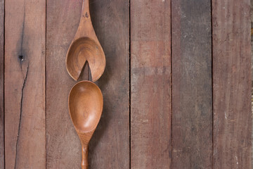 Various wooden spoons of wooden background