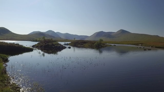 Stunning drone shot in Scotland of Lochan na h-Achlaise by Rannoch Moor on the A83 towards Glen Coe
