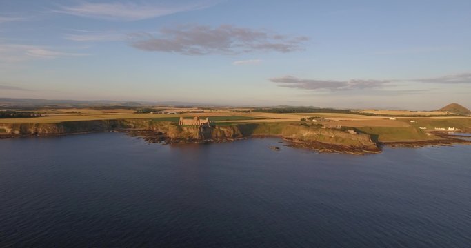 Aerial shot off the coast heading towards Tantallon Castle near North Berick, Scotland
