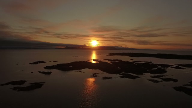 Aerial shot of the coast line on the west coast of Scotland during sunsey near Arisaig with Rum and Eigg in the background
