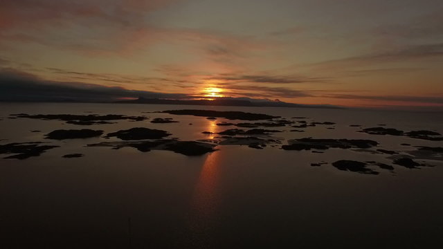 Aerial shot of the coast line on the west coast of Scotland during sunsey near Arisaig with Rum and Eigg in the background
