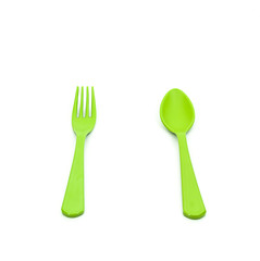 plastic green spoon and fork isolated on white background