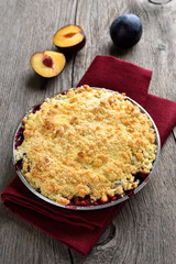 Fruit pie with plums, top view