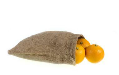 orange in burlap sack, isolated on white background