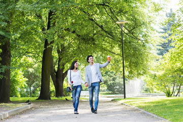 Young beautiful couple having a date in the park