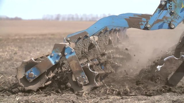 Close up of a tractor seeding, plowing and cultivating the field in the spring.   Slow Motion Shot.