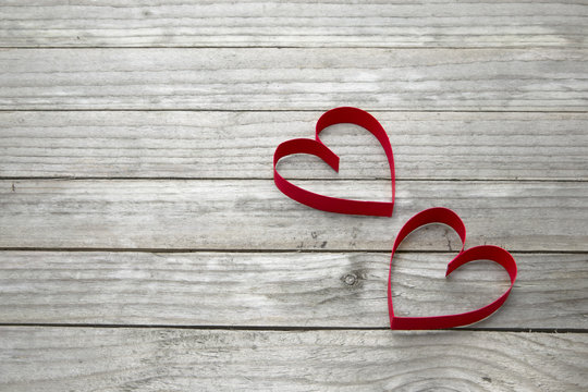 Two hearts on a wood background