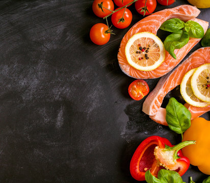 Raw salmon steaks and fresh ingredients for cooking