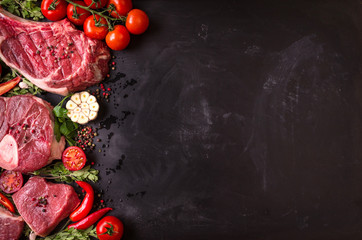 Raw meat steaks on a dark background ready to roasting