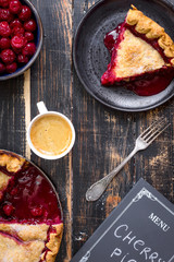 Cherry pie, cup of coffee and menu chalkboard