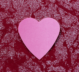 Valentine - paper pink heart against a red surface. Copy space. Free space for text, Close-up, top view