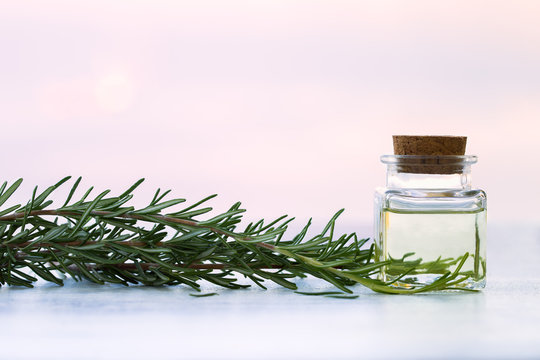 Rosemary aromatherapy essential oil  in bottle on sunset