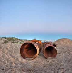 Wide view of unassembled dredge pipes ends. 