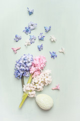 Light pastel Easter greeting card with hyacinths flowers and egg, top view