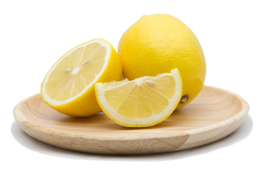 Lemons in wood dish isolated on white