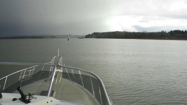 Bow of a boat as it moves through calm waters on the Columbia River near Astoria, Oregon