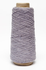 The cone of colored wool thread on a white background