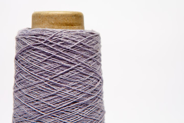 The cone of colored wool thread on a white background