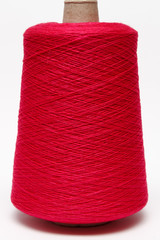 The cone of colored wool thread on a white background