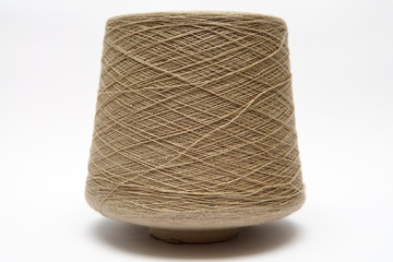 The cone of colored wool thread on a white background