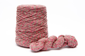 The cone of colored wool thread on a white background