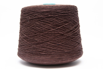 The cone of colored wool thread on a white background
