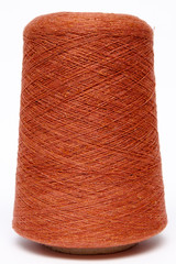 The cone of colored wool thread on a white background