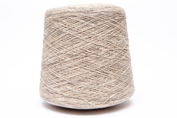 The cone of colored wool thread on a white background