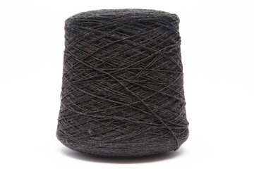 The cone of colored wool thread on a white background