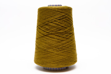 The cone of colored wool thread on a white background