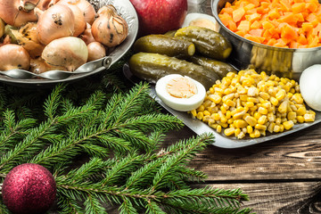 Vegetables for christmas salad on wooden table.