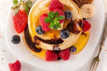 Stack of pancakes with fresh berries
