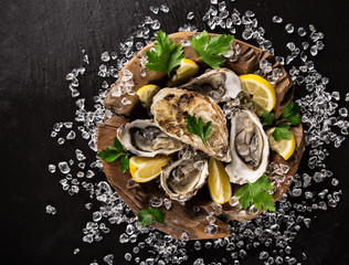 Fresh oysters on a black stone