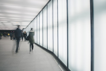 People in bright modern tunnel in the city