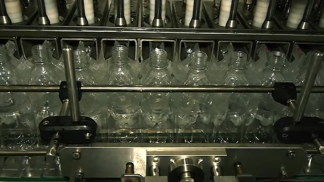 plastic bottles filled with water on the conveyor