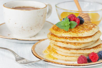 Pancakes with honey and berries