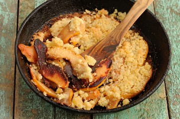 Homemade quince crumble pie in cast iron pan