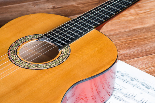 Acoustic guitar and wooden background